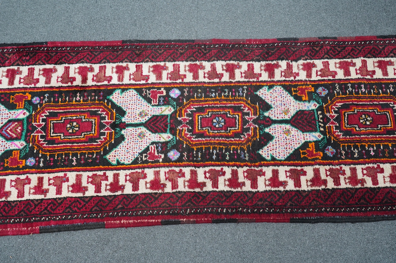 A Turkish red ground geometric runner, 266 x 63cm. Condition - good